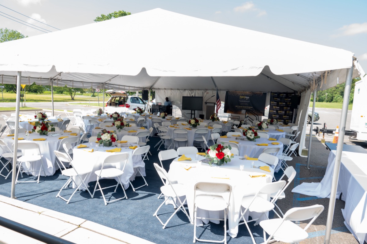 White tent gala setup in the Byrne Center parking lot
